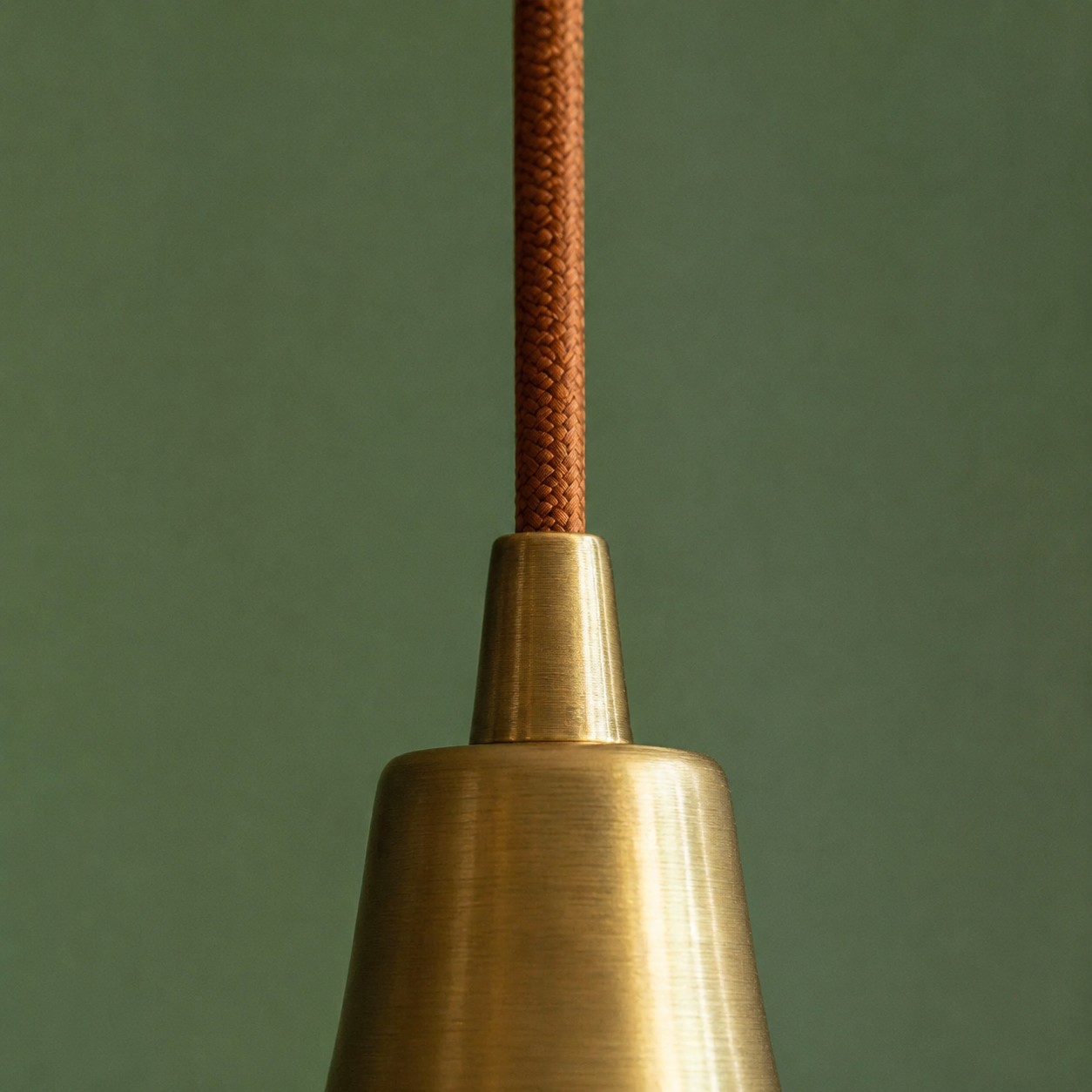 Close view of the pendant cord and brass canopy connector